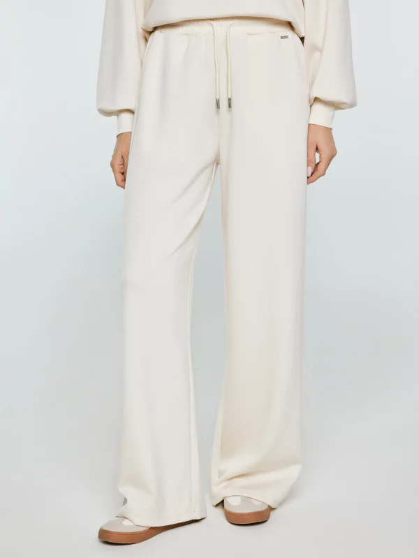 Spodnie damskie dresowe z szeroką nogawką kremowe Lunarap 102