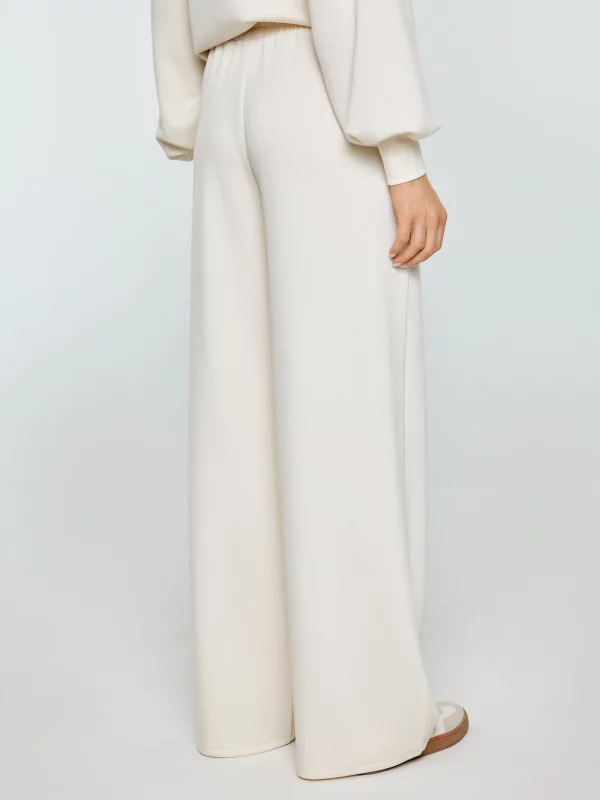 Spodnie damskie dresowe z szeroką nogawką kremowe Lunarap 102