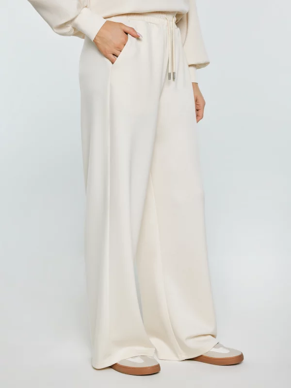 Spodnie damskie dresowe z szeroką nogawką kremowe Lunarap 102